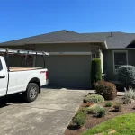 white truck parked in front of home with complete roof repair.