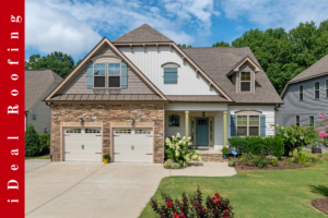 Charming suburban house with stone and siding facade, double garages, and a manicured lawn. "iDeal Roofing" text in a red vertical banner on the left.