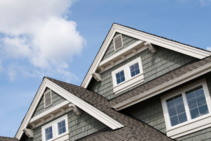 Exterior view of a gabled house roof, illustrating the importance of roof inspection tips for home maintenance.