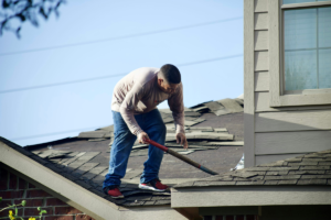 A contractor identifies damaged shingles, a key part of roof inspection tips for identifying early leaks.