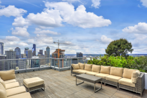 Luxury commercial rooftop lounge with seating; high foot traffic and weight shortens a commercial roof's life.