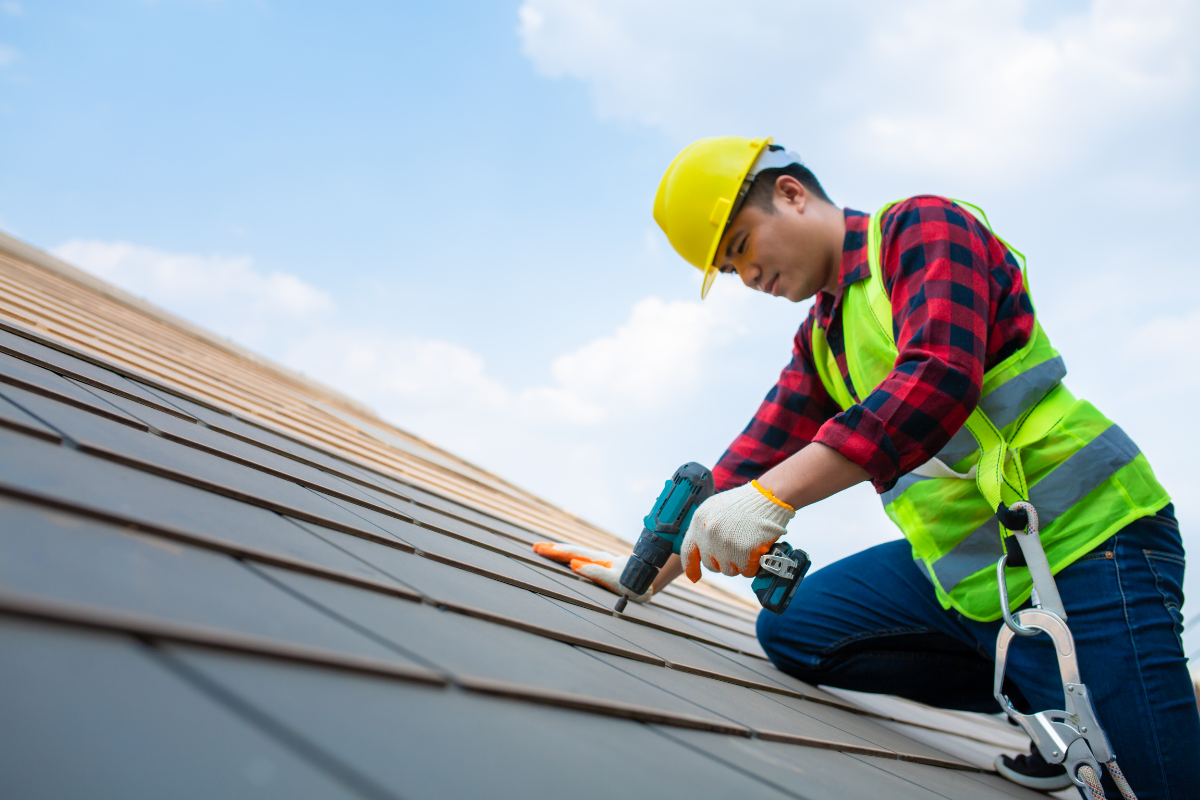 Worker Fixing Roof Tiles