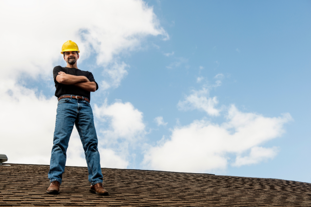 Roofer standing at the top of the roof
